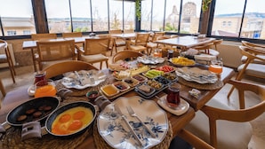 Um buffet de café da manhã com diversas opções de comida e vista para a cidade.