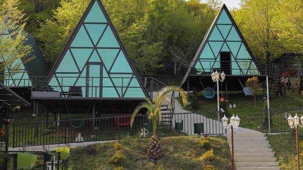 A building with a triangular facade and a staircase leading up to it. - Panorama Sormoni (Tsqaltubo)