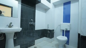 A bathroom with a sink, toilet, and shower area. - Hotel Kishangarh Jaisalmer (Jaisalmer)