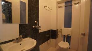 A bathroom with a sink, toilet, and shower. - Hotel Kishangarh Jaisalmer (Jaisalmer)