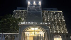 The Sundr Palace with illuminated string lights, a grand entrance, and a sign above the door. - The Sunder Palace- Luxury Boutique Hotel (Jaipur)