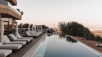 Indoor pool, outdoor pool, pool umbrellas, pool loungers