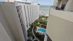 A high-rise hotel with a pool area, including a swimming pool and lounge chairs, surrounded by greenery. - Royale Palms 1405 3 Br Oceanview in Kingston, Pool (Myrtle Beach)