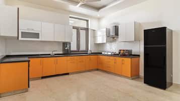 Fridge, microwave, cookware/dishes/utensils, dining tables