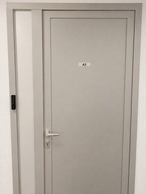 A closed door with a keypad lock and a keyhole, labeled 'A2'. - Mediterraneo apartment A2 (Sukošan)
