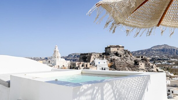 A rooftop pool with a view of a white building and a church. - Amphora Helios Gem - Private Jacuzzi and Views (Santorini)