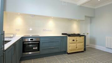 A modern kitchen with a built-in oven, a stove, and a refrigerator.