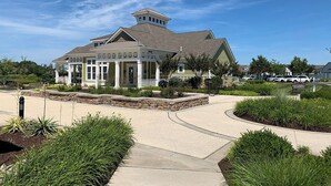 A large, single-story building with a prominent entrance and a small tower-like structure on the roof. - 4 BR Beauty-Millville by the Sea~ Minutes to Bethany Beach -23548 Bonfire Way (Millville)