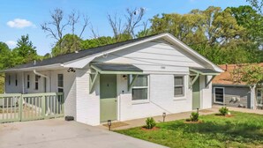 A single-story house with a green door, a garage, and a number 1300 on the front. - Fully Furnished 2BR Near Duke & VA Hospital Ideal for Medical & Extended Stays (Durham)