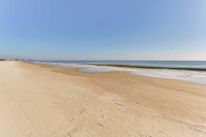 A sandy beach with footprints and a calm sea under a clear sky. - Beach + Pool Access: Hilton Head Resort Getaway! (Hilton Head Island)