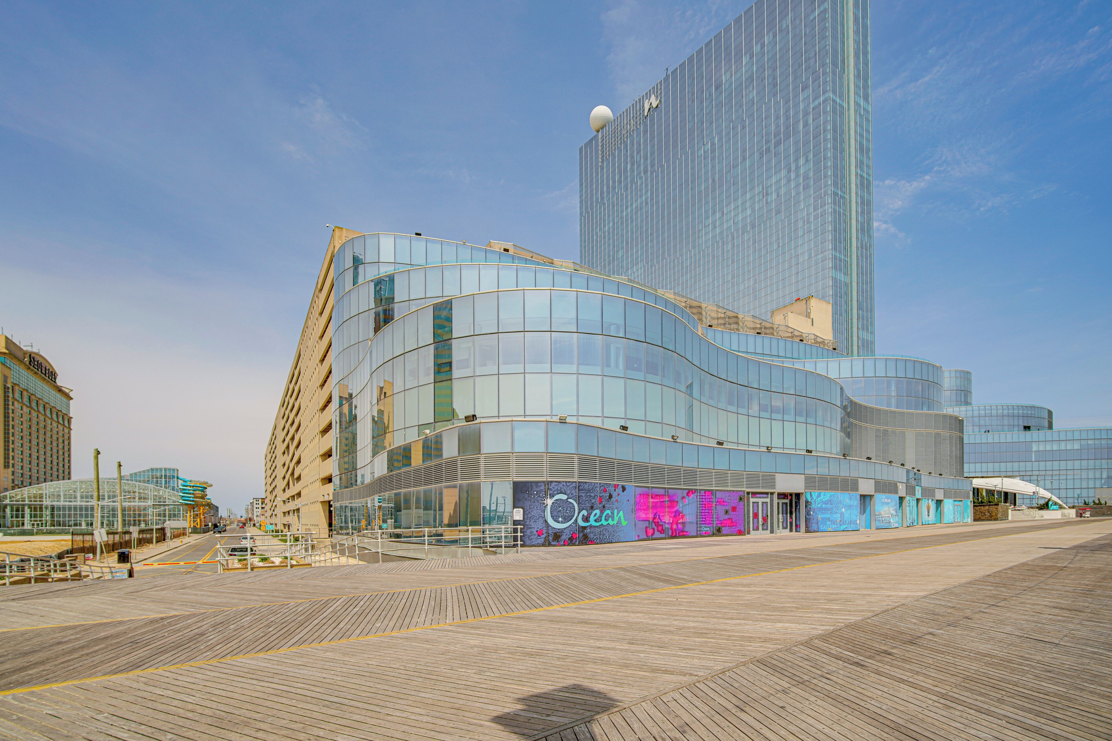 A modern building with a curved glass facade and a prominent 'Ocean' sign on the ground floor.