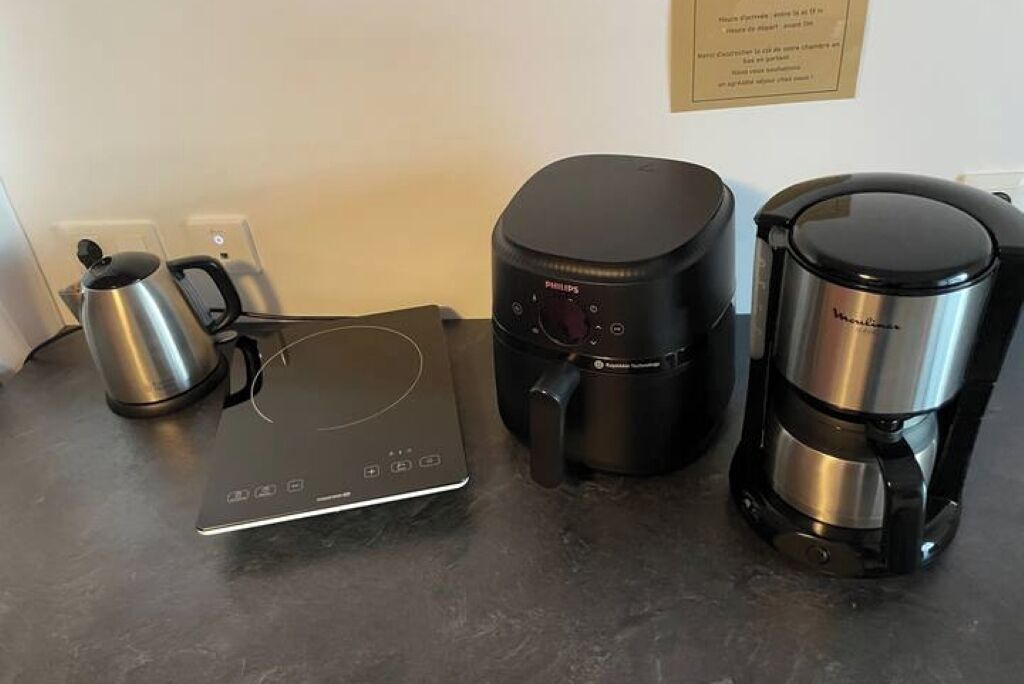 A kitchen setup with a coffee maker, a kettle, and a toaster.