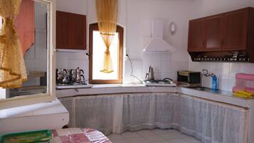 Mini-fridge, stovetop, cookware/dishes/utensils