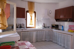 Mini-fridge, stovetop, cookware/dishes/utensils