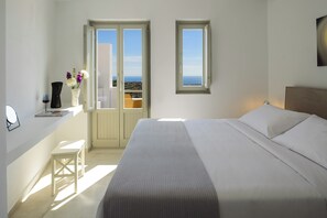 Relax in this serene bedroom with a large bed and a window offering a view of the surrounding landscape.