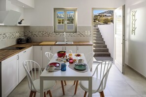 Enjoy a meal at the kitchen's dining table, which seats four, with a view of the surrounding landscape.