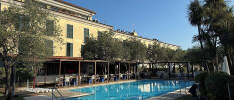 Seasonal outdoor pool, open 10:00 AM to 6:00 PM, pool umbrellas