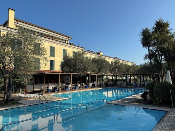 Seasonal outdoor pool, open 10:00 AM to 6:00 PM, pool umbrellas