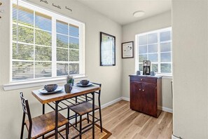 A kitchen with a wooden table and chairs, a coffee maker, and a cabinet. - Perfect Private Central Coast Getaway in Salinas! (Salinas)