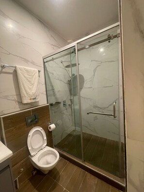 Separate tub and shower, slippers, towels, toilet paper