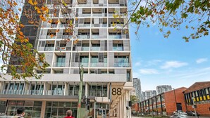 A modern multi-story building with a prominent number '88' on the facade.