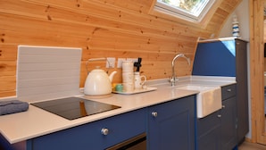 A compact kitchen with wooden walls, a skylight, a sink, and a kettle. - Luxury Glamping Escape - Hot tub - West Coast Scotland (Innellan)