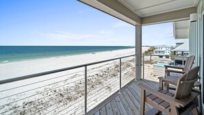 A wooden deck with chairs overlooking a beach and ocean. - Bird of Paradise: Beachfront Views, Multiple Living Areas, Pet-Friendly (Mexico Beach)