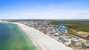 An aerial view of a coastal town with a beach, houses, and a marina. - Bird of Paradise: Beachfront Views, Multiple Living Areas, Pet-Friendly (Mexico Beach)