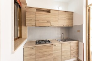 Fridge, stovetop, cookware/dishes/utensils, dining tables