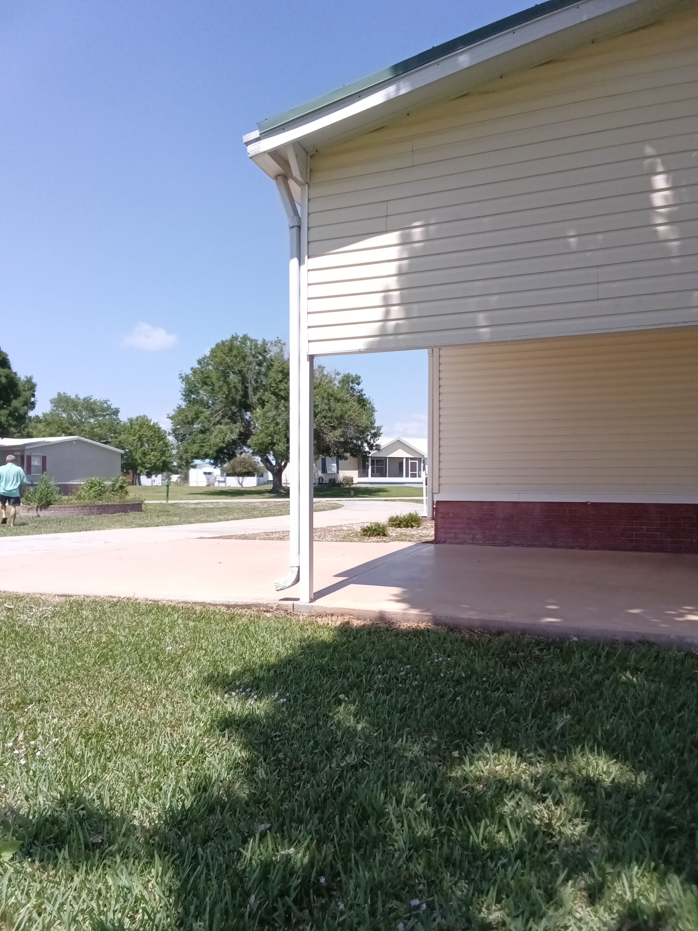 A house with a covered porch and a well-maintained lawn.