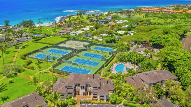 A residential area with multiple tennis courts, a swimming pool, and houses with a view of the ocean. - Summer Deal Poipu Beach Condo 5 Min Walk to Ocean Pools and Hot Tub (KOLOA)