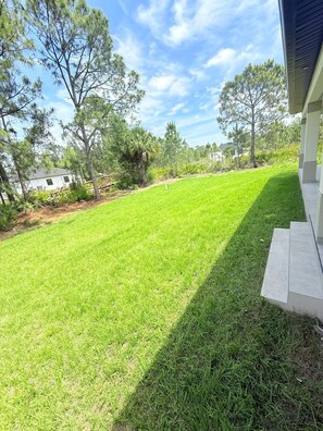 Stroll through the beautifully manicured lawn surrounded by lush trees.
