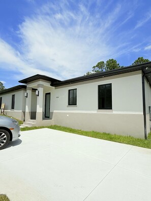 Stunning two-story home with a flat roof and inviting front porch.