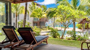 A wooden deck with two lounge chairs and a small gazebo. - Beachfront chic retreat (Belle Mare)