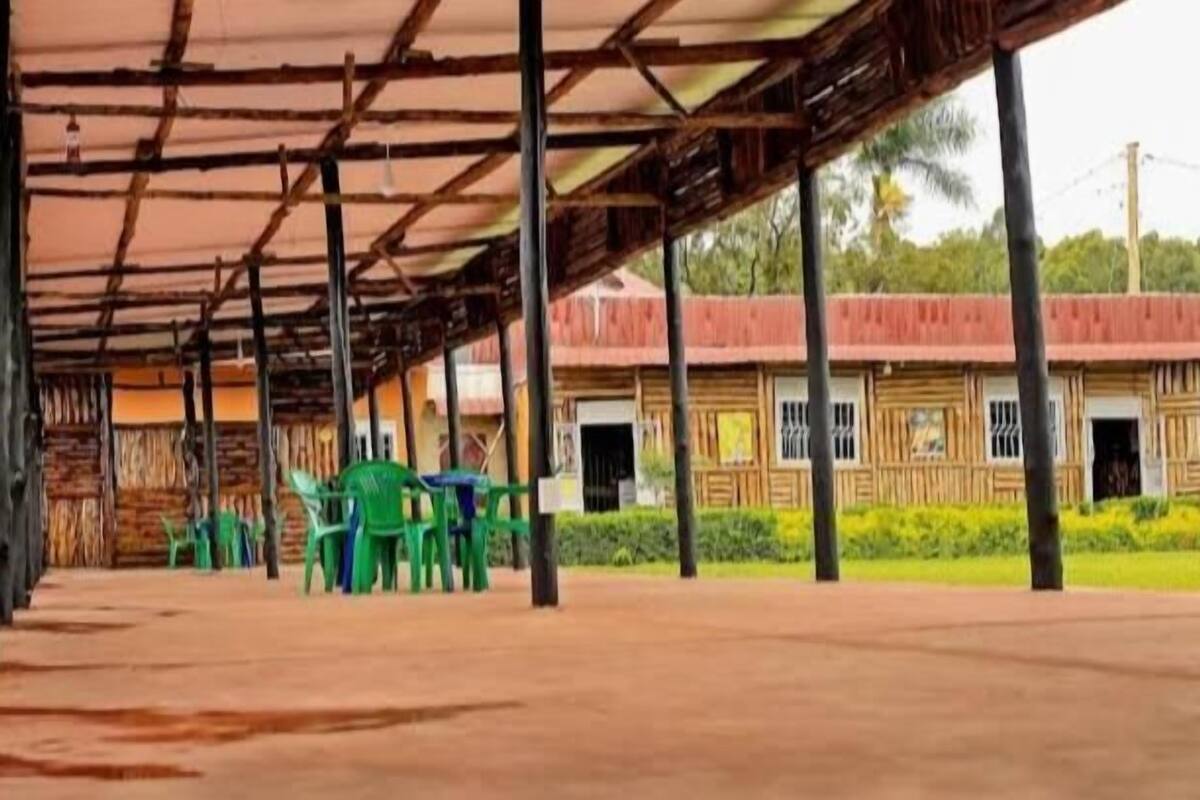 A covered outdoor area with a building in the background.
