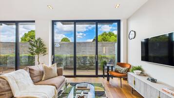 Deluxe Apartment, Balcony | Living area | 55-inch Smart TV with digital channels, Netflix, streaming services