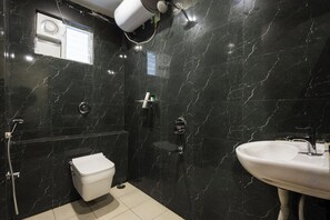 A modern bathroom with a toilet, shower, and sink. - Whiteridge Premium Hotel Hitech city (Hyderabad)