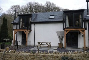 Stunning two-story building with a balcony and a charming ground floor entrance.