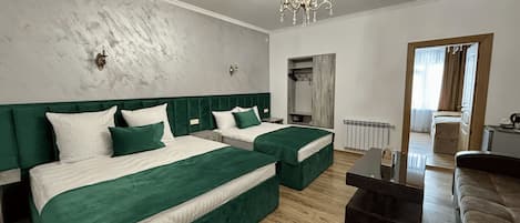 Family Quadruple Room | Minibar, in-room safe, desk, laptop workspace