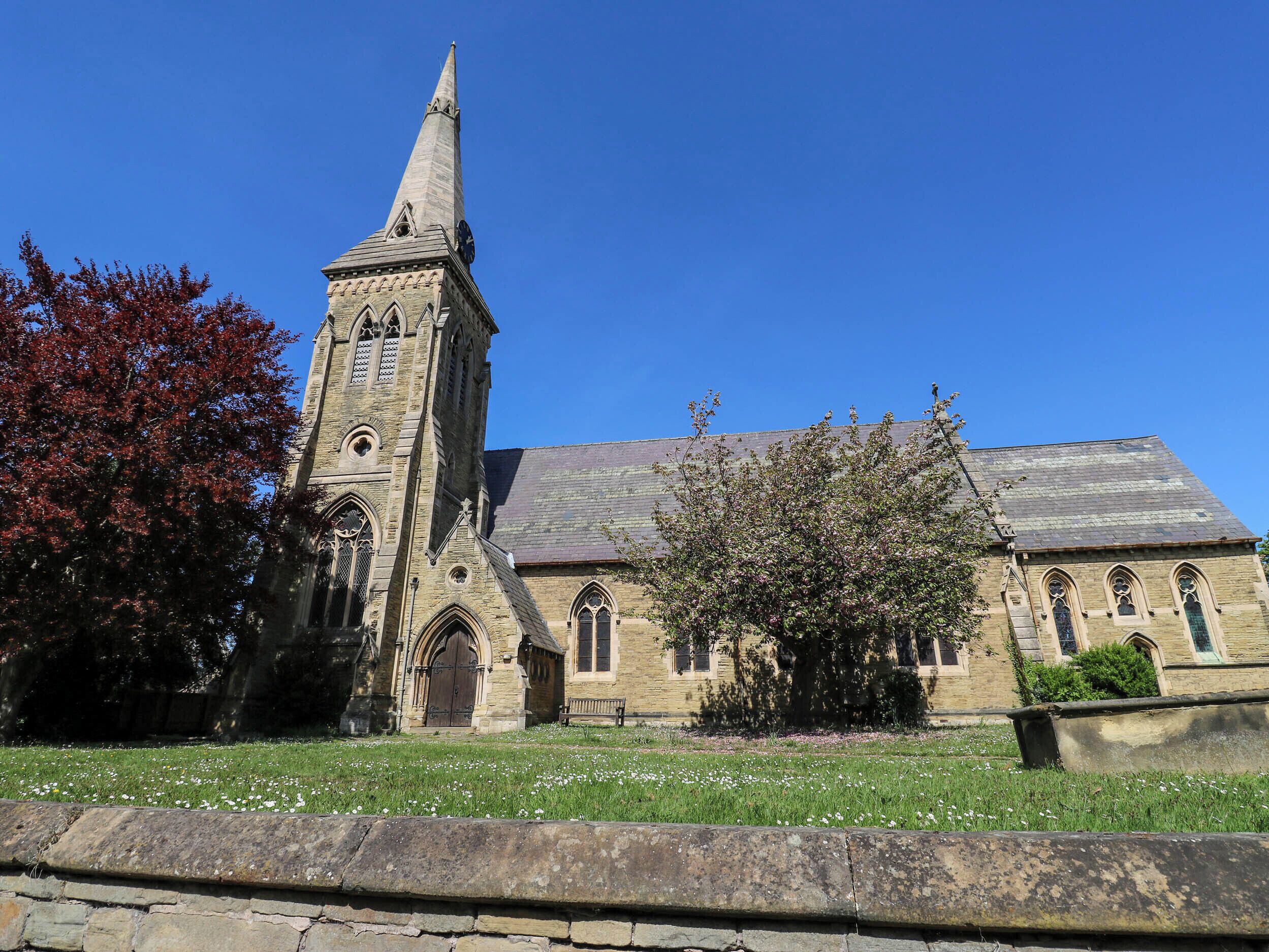 A church with a tall tower and arched windows.