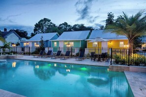 A row of colorful cottages with a swimming pool in the foreground. - Historic St. Augustine Bungalow w/ Hot Tub & (St. Augustine)