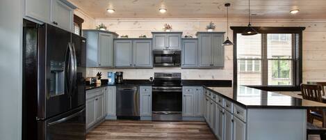 Dishwasher, cookware/dishes/utensils, paper towels, dining tables