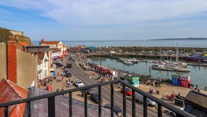 A coastal town with a marina, buildings, and a clear sky. - Apartment 3 (Scarborough)