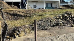 A two-story house with a balcony, a front porch, and a stone retaining wall. - Lakefront Home Huron/Vermillion Amazing View (Vermilion)