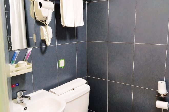Shower, hair dryer, slippers, towels