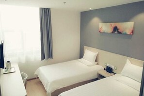 A hotel room with two beds, a desk, a chair, and a painting on the wall. - Xiaomei Hotel (Beijing Universal Studios Tuqiao Subway Station) (Beijing)