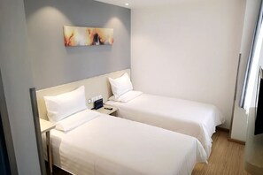 A hotel room with two single beds, a nightstand, a painting on the wall, and a window. - Xiaomei Hotel (Beijing Universal Studios Tuqiao Subway Station) (Beijing)