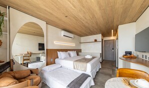 A modern hotel room with a wooden ceiling, a large mirror, a bed with white bedding, a desk with a flat-screen TV, and a seating area with a leather chair. - Nwts - Studios With Side sea View in Maceio II (Maceió)