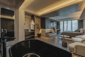 A modern hotel room with a large bed, a sofa, a desk, and a black chair. - HOTEL CASA KAVIA (Mexico City)