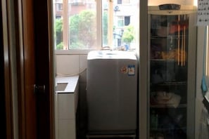 A compact room with a refrigerator, a window, and a glass cabinet. - 99 Inn (Shanghai Liuying Road) (Shanghai)
